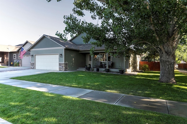 5334 Woodrow Ln, Lolo, MT 59847 - view of front of home featuring a garage, stone siding, driveway, and a porch