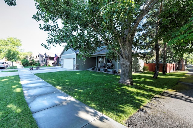 5334 Woodrow Ln, Lolo, MT 59847 - view of front of property featuring an attached garage, a front yard, covered porch, and concrete driveway
