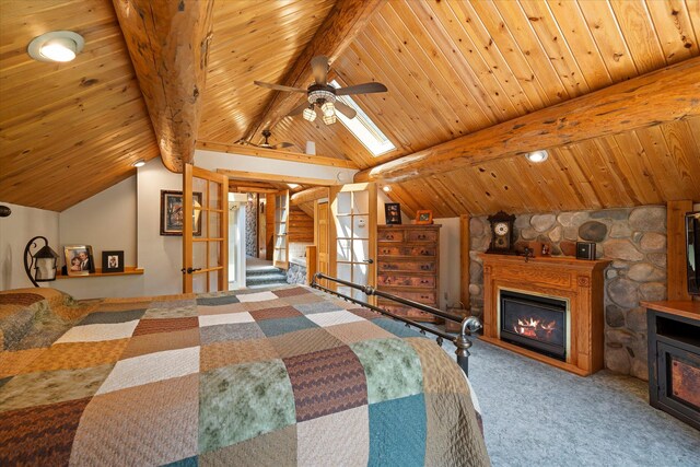 421 Swanson Lodge Rd, Troy, MT 59935 - bedroom featuring a glass covered fireplace, wood ceiling, and carpet