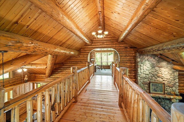 421 Swanson Lodge Rd, Troy, MT 59935 - hallway with an upstairs landing, wooden ceiling, a chandelier, rustic walls, and light wood-style flooring