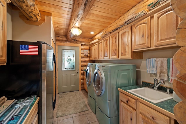 421 Swanson Lodge Rd, Troy, MT 59935 - laundry area with independent washer and dryer, wood ceiling, log walls, light tile patterned flooring, and cabinet space