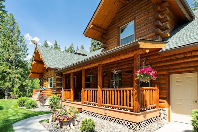 421 Swanson Lodge Rd, Troy, MT 59935 - view of home's exterior featuring log exterior, covered porch, and roof with shingles