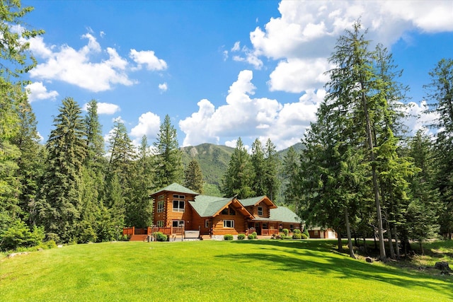 421 Swanson Lodge Rd, Troy, MT 59935 - rear view of property with a yard, a deck with mountain view, and a wooded view