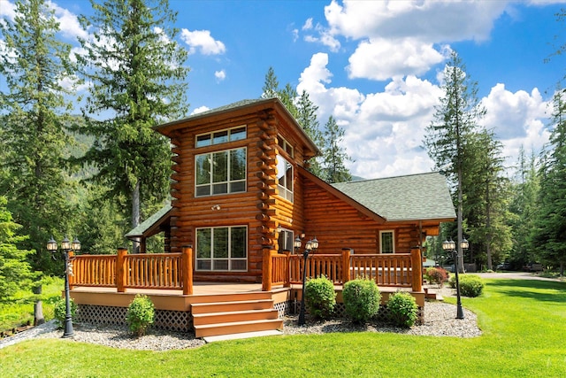 421 Swanson Lodge Rd, Troy, MT 59935 - rear view of property featuring log exterior, a lawn, a deck, and a shingled roof