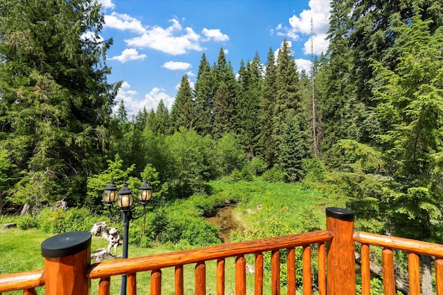 421 Swanson Lodge Rd, Troy, MT 59935 - wooden terrace featuring a forest view and a yard