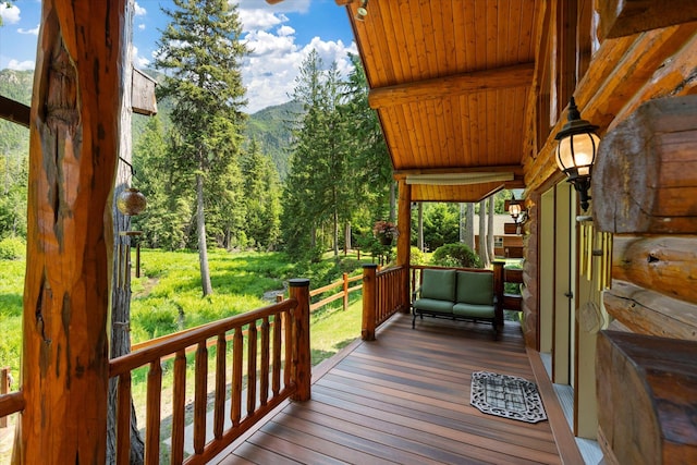 421 Swanson Lodge Rd, Troy, MT 59935 - wooden terrace featuring a view of trees
