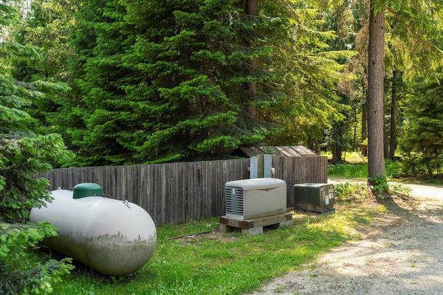 421 Swanson Lodge Rd, Troy, MT 59935 - exterior view of gas tank and a heavily wooded area
