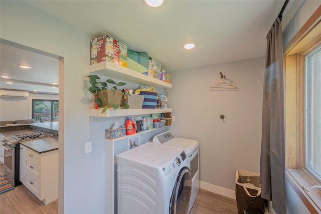 1520 Highland St, Helena, MT 59601 - washroom featuring a wall mounted air conditioner, washing machine and clothes dryer, light wood finished floors, baseboards, and recessed lighting