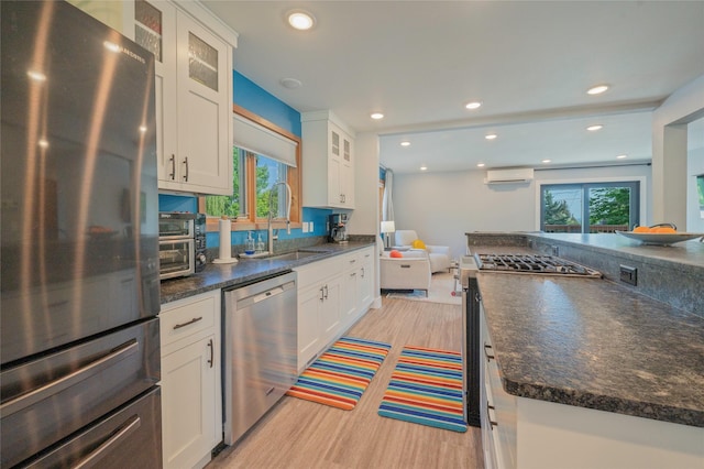 1520 Highland St, Helena, MT 59601 - kitchen with stainless steel appliances, light wood-type flooring, a wall mounted air conditioner, plenty of natural light, and recessed lighting