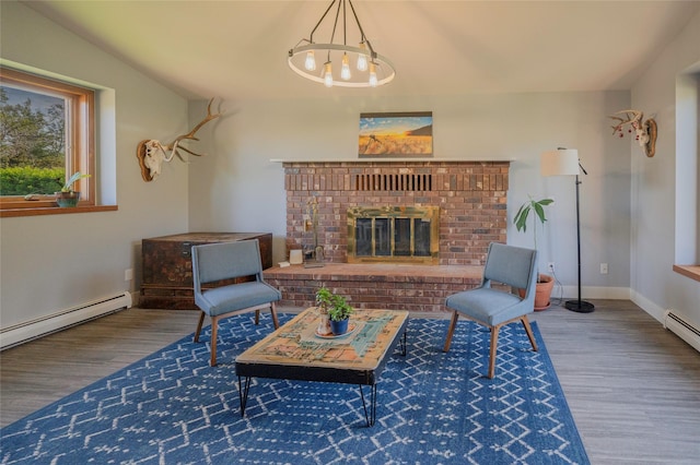 1520 Highland St, Helena, MT 59601 - living area with wood finished floors, a chandelier, a brick fireplace, a baseboard radiator, and baseboards