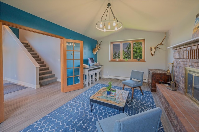 1520 Highland St, Helena, MT 59601 - living area with a baseboard radiator, a chandelier, wood finished floors, baseboards, and a fireplace