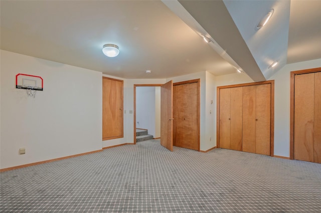 1520 Highland St, Helena, MT 59601 - unfurnished bedroom with light colored carpet, baseboards, and two closets