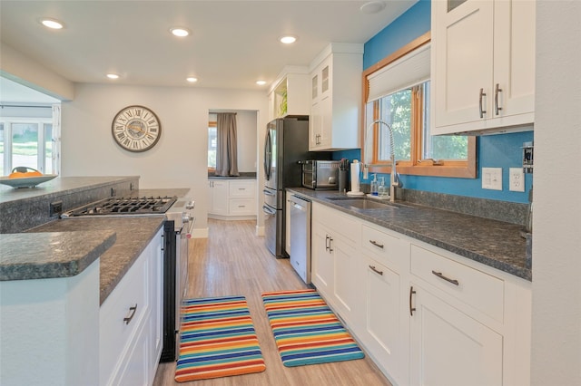 1520 Highland St, Helena, MT 59601 - kitchen featuring stainless steel appliances, a sink, light wood-style floors, white cabinetry, and recessed lighting