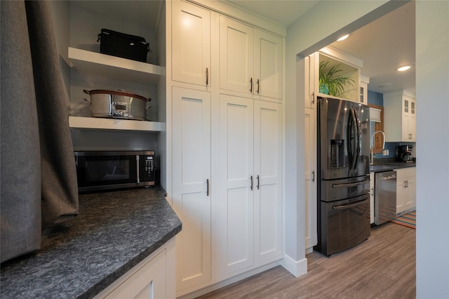 1520 Highland St, Helena, MT 59601 - kitchen with stainless steel appliances, open shelves, light wood-style floors, dark countertops, and white cabinetry