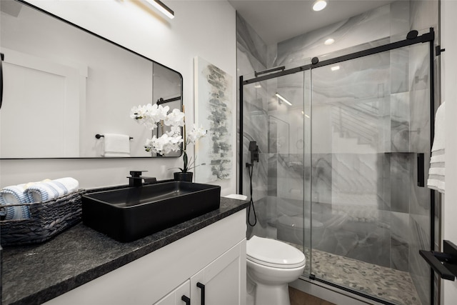208 Cowboy Dr, Columbia Falls, MT 59912 - bathroom with vanity, toilet, a marble finish shower, and recessed lighting