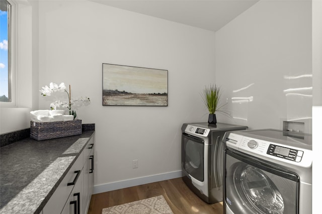 208 Cowboy Dr, Columbia Falls, MT 59912 - laundry area with washer and clothes dryer, dark wood-type flooring, baseboards, and cabinet space