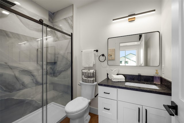208 Cowboy Dr, Columbia Falls, MT 59912 - full bathroom with toilet, vanity, a marble finish shower, and wood finished floors