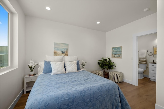 208 Cowboy Dr, Columbia Falls, MT 59912 - bedroom featuring wood finished floors, baseboards, recessed lighting, and ensuite bath