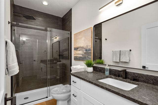 208 Cowboy Dr, Columbia Falls, MT 59912 - bathroom with vanity, toilet, a shower stall, and recessed lighting