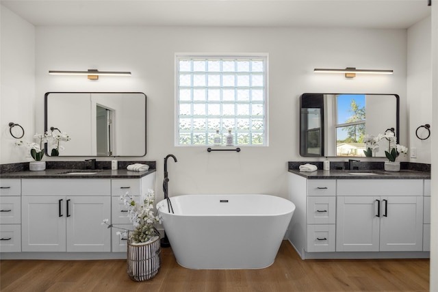208 Cowboy Dr, Columbia Falls, MT 59912 - full bath featuring wood finished floors, two vanities, and a freestanding tub