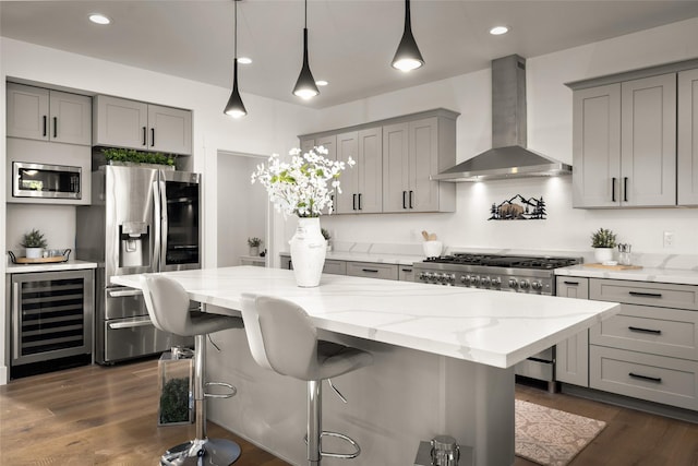 208 Cowboy Dr, Columbia Falls, MT 59912 - kitchen featuring wall chimney range hood, gray cabinets, stainless steel appliances, wine cooler, and light stone countertops
