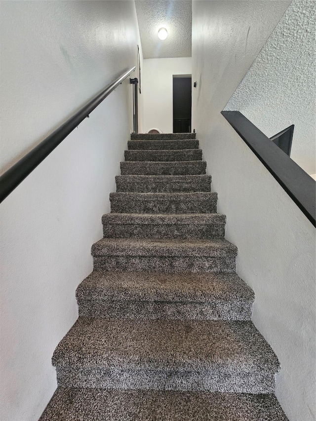 901 Rodgers St Unit 7, Missoula, MT 59802 - staircase with a textured ceiling