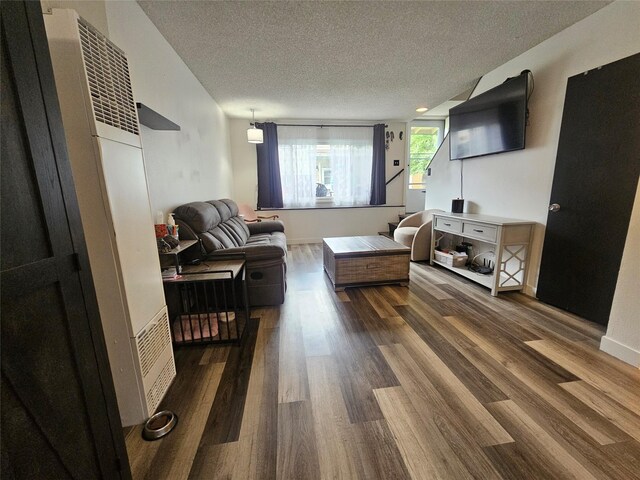 901 Rodgers St Unit 7, Missoula, MT 59802 - living room featuring a textured ceiling, dark wood-type flooring, and a heating unit