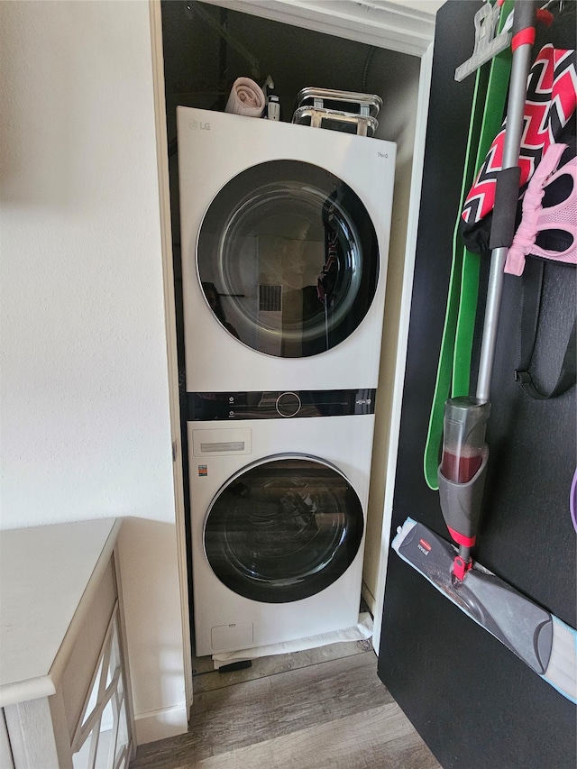 901 Rodgers St Unit 7, Missoula, MT 59802 - washroom featuring estacked washer and dryer and wood finished floors