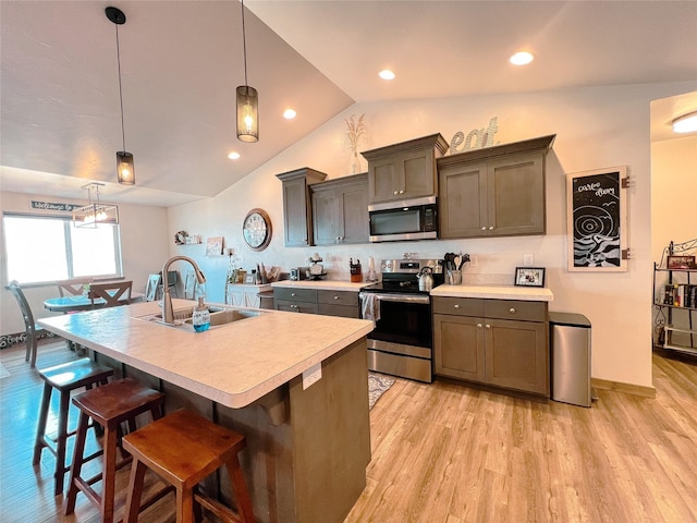 3075 Callaway Dr, East Helena, MT 59635 - kitchen with appliances with stainless steel finishes, a sink, light countertops, light wood-style flooring, and vaulted ceiling