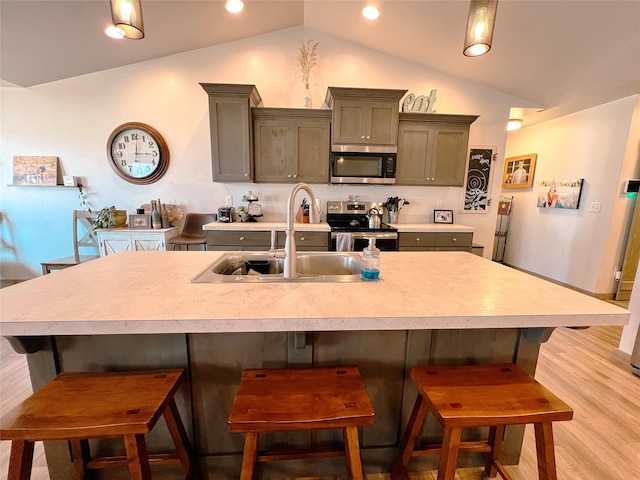 3075 Callaway Dr, East Helena, MT 59635 - kitchen featuring appliances with stainless steel finishes, a sink, lofted ceiling, light countertops, and light wood-type flooring
