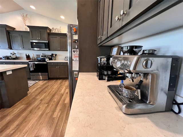 3075 Callaway Dr, East Helena, MT 59635 - kitchen with appliances with stainless steel finishes, light countertops, lofted ceiling, light wood-style flooring, and recessed lighting