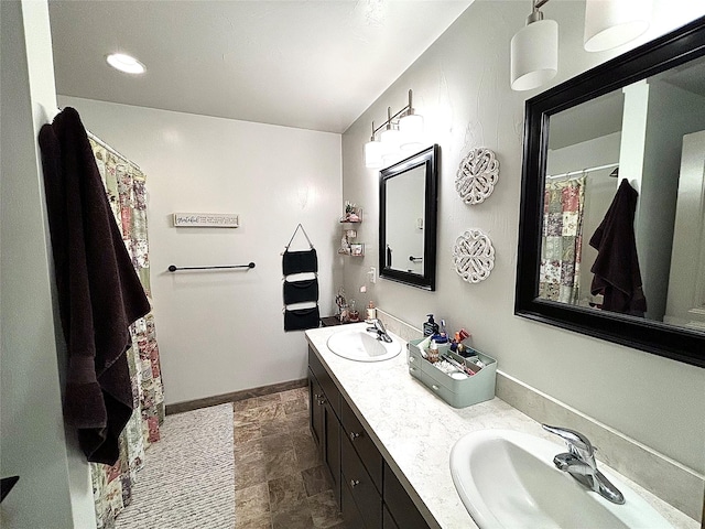 3075 Callaway Dr, East Helena, MT 59635 - full bathroom featuring double vanity, baseboards, and stone finish floors