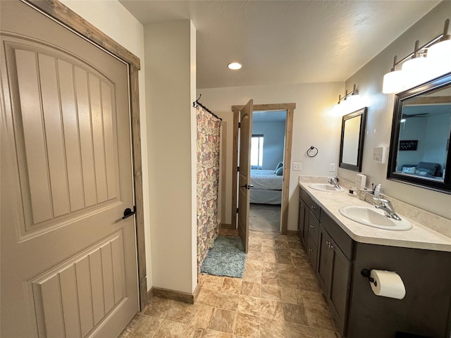 3075 Callaway Dr, East Helena, MT 59635 - bathroom with ensuite bathroom, baseboards, double vanity, stone finish floors, and a shower with curtain