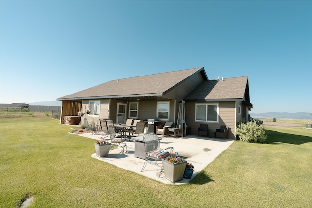 3075 Callaway Dr, East Helena, MT 59635 - rear view of house with a patio, a lawn, roof with shingles, and a mountain view