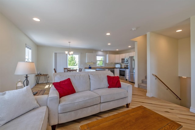 5196 Stallion Ridge Dr, Helena, MT 59602 - living room with recessed lighting, a chandelier, light wood-type flooring, stairway, and baseboards