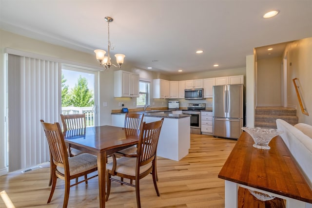 5196 Stallion Ridge Dr, Helena, MT 59602 - dining area with light wood-style floors, recessed lighting, a chandelier, stairs, and baseboards