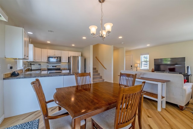 5196 Stallion Ridge Dr, Helena, MT 59602 - dining area featuring light wood-style flooring, stairs, recessed lighting, and a chandelier