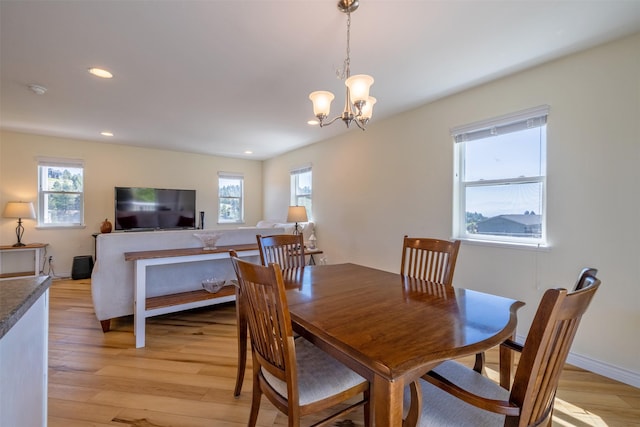 5196 Stallion Ridge Dr, Helena, MT 59602 - dining room with healthy amount of natural light, light wood-style floors, a chandelier, recessed lighting, and baseboards
