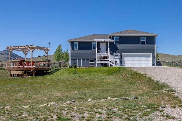 5196 Stallion Ridge Dr, Helena, MT 59602 - back of house with gravel driveway, a pergola, a yard, a garage, and a shingled roof