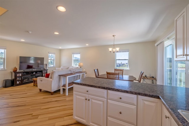 5196 Stallion Ridge Dr, Helena, MT 59602 - kitchen featuring a chandelier, light wood finished floors, plenty of natural light, dark countertops, and recessed lighting