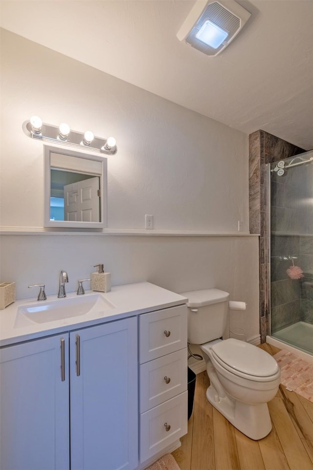 5196 Stallion Ridge Dr, Helena, MT 59602 - bathroom featuring toilet, tiled shower, wood finished floors, and vanity