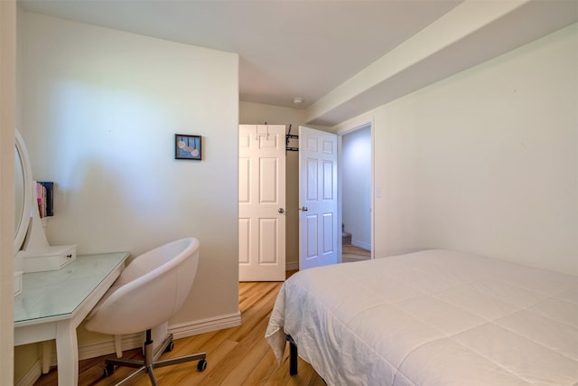 5196 Stallion Ridge Dr, Helena, MT 59602 - bedroom with wood finished floors, baseboards, and an office area