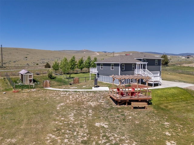 5196 Stallion Ridge Dr, Helena, MT 59602 - back of property featuring a deck with mountain view, a rural view, roof with shingles, and a pergola