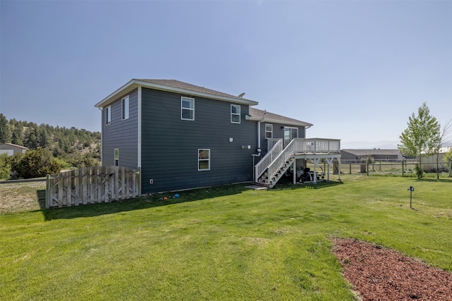 5196 Stallion Ridge Dr, Helena, MT 59602 - rear view of house with stairs and a wooden deck