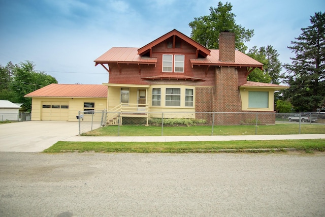 412 1st Ave E, Eureka, MT 59917 - view of front facade featuring a chimney, driveway, metal roof, and a garage