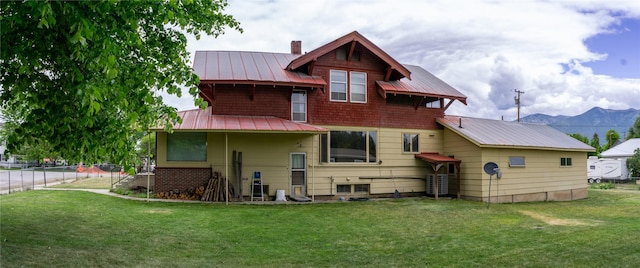 412 1st Ave E, Eureka, MT 59917 - back of property with metal roof, a standing seam roof, a chimney, and central air condition unit