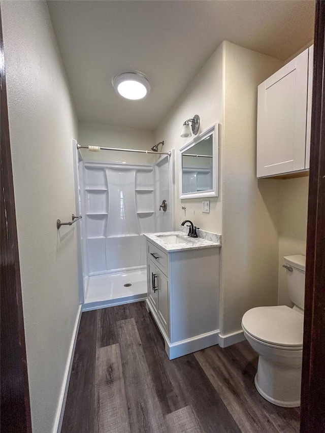 412 1st Ave E, Eureka, MT 59917 - bathroom featuring wood finished floors, toilet, baseboards, and a shower