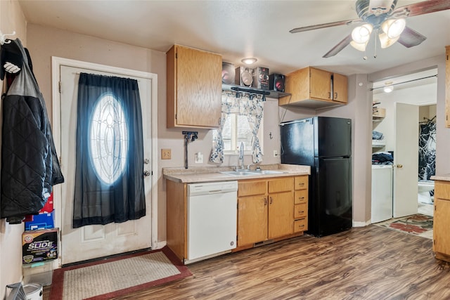 424 4th Ave, Victor, MT 59875 - kitchen featuring white dishwasher, freestanding refrigerator, a sink, light countertops, and wood finished floors