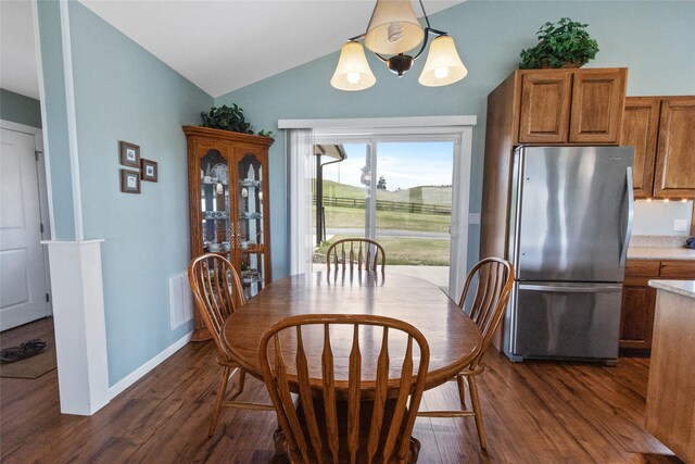 760 Lundeen Rd, Eureka, MT 59917 - dining space with lofted ceiling, dark wood-type flooring, and baseboards