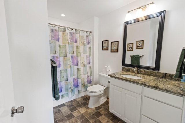 760 Lundeen Rd, Eureka, MT 59917 - bathroom featuring toilet, vanity, and stone finish flooring